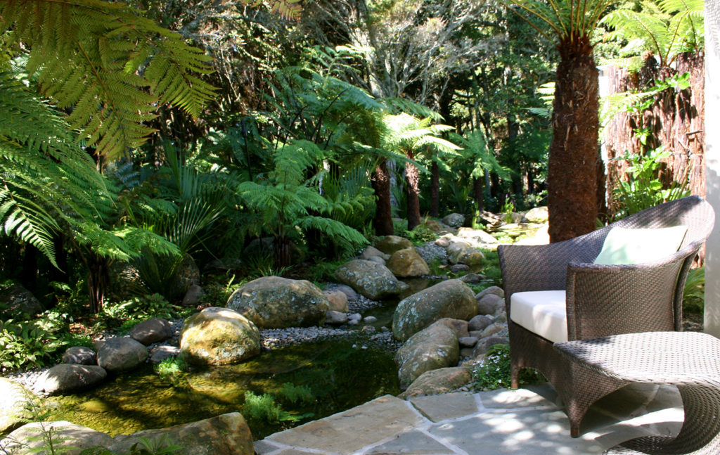 Relax amongst the subtropical plantings and rocky stream